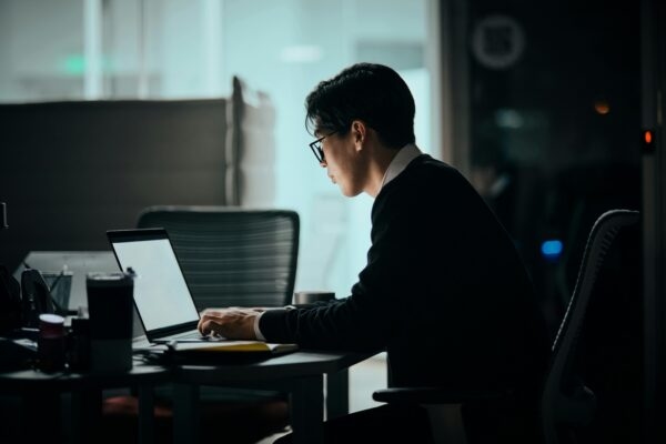 Man at desk using laptop